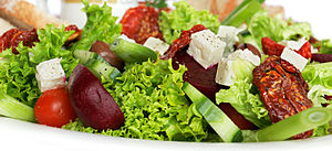 A garden salad with lettuce, sundried tomatoes...