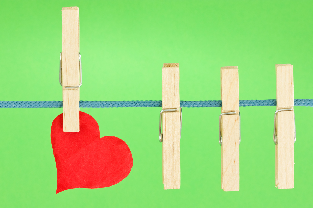 clothesline with a red heart, hung on green background